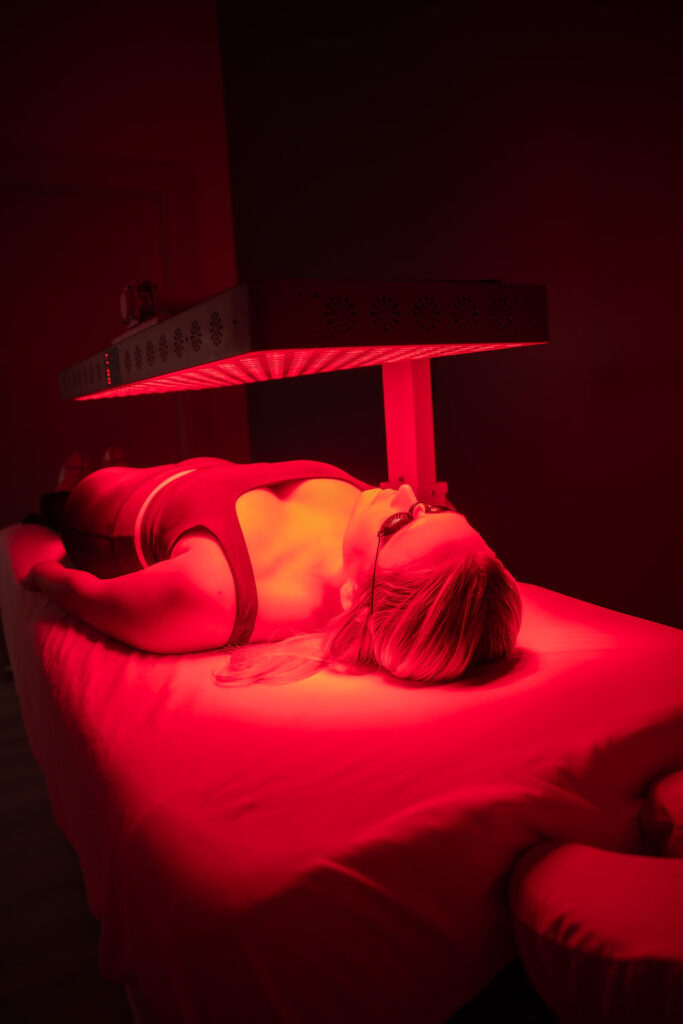 A woman receiving Lumi red light therapy for skin rejuvenation and anti-aging at Sugar and Mend in Little Elm, Texas.
