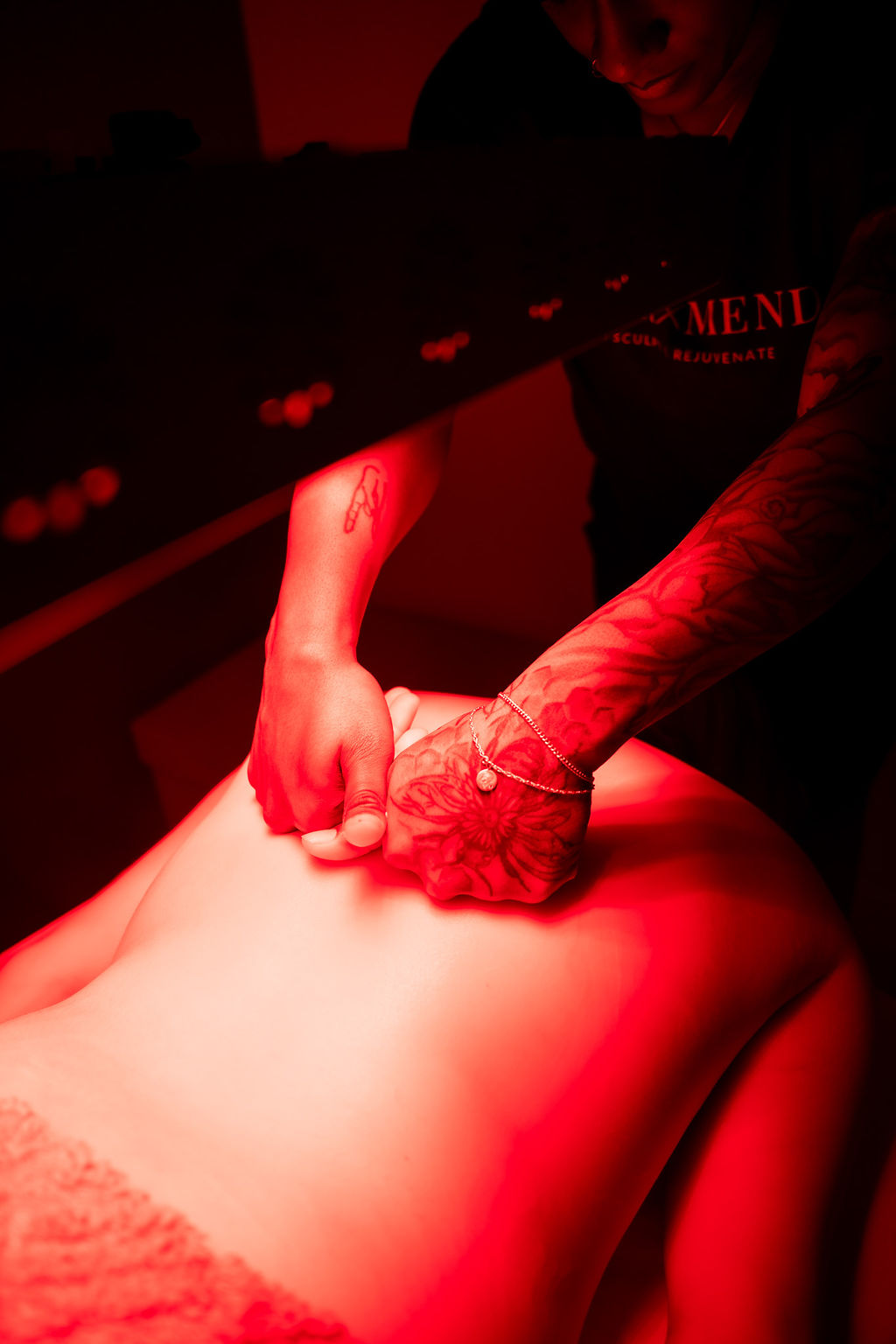 Close-up of manual therapy and myofascial release during a red light therapy session at Sugar and Mend.